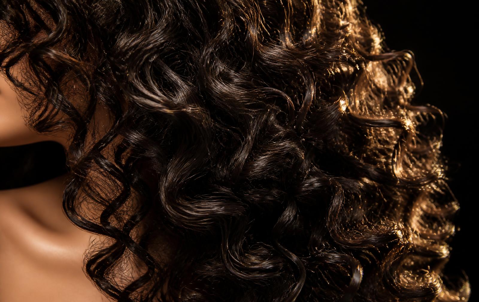 Close-up of healthy, full hair catching warm light